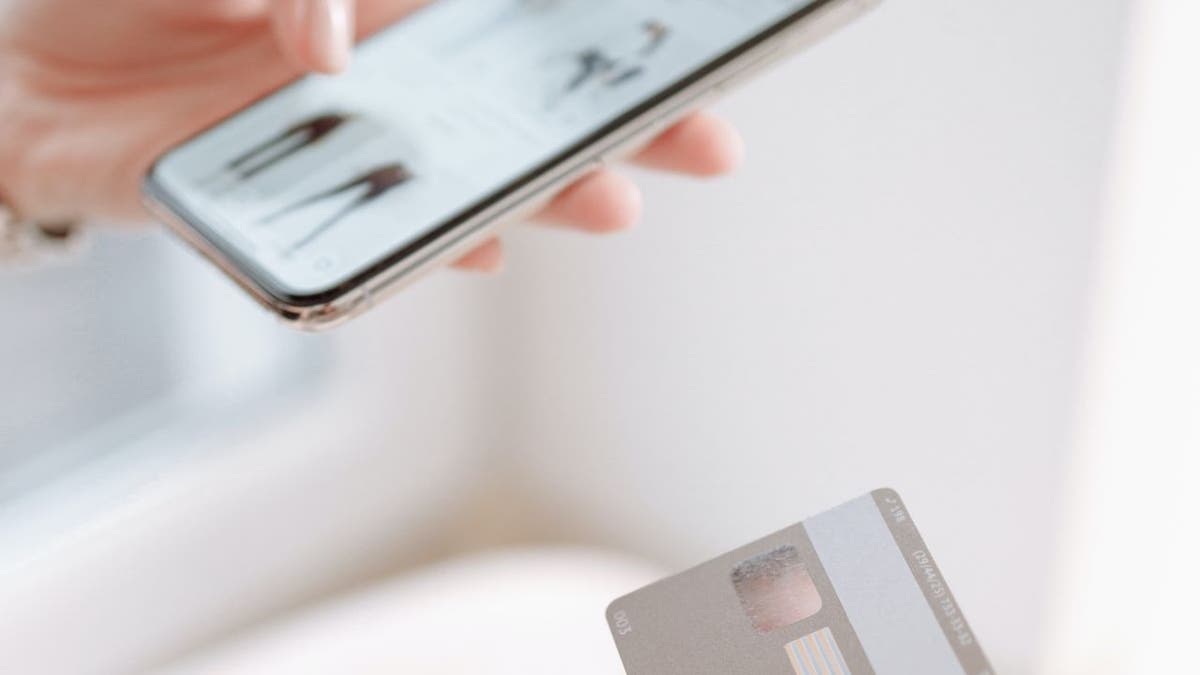 Stock photo shows a woman shopping online with a smartphone