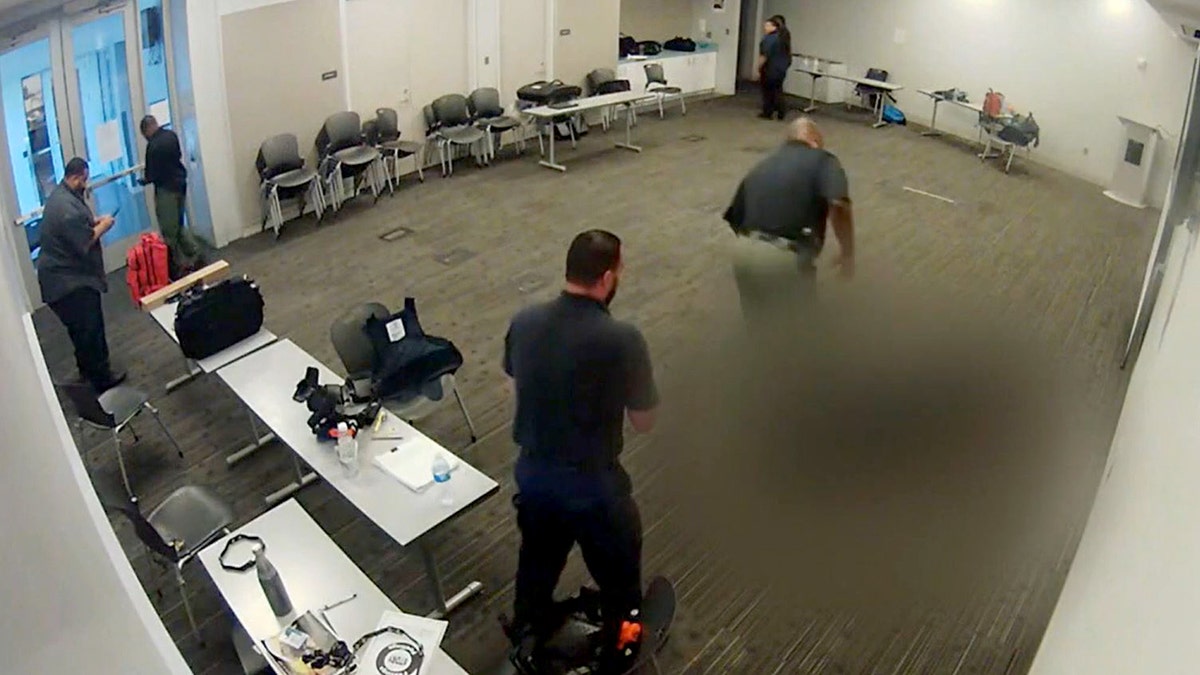 Blurred picture of the library officer shooting suspect on the ground