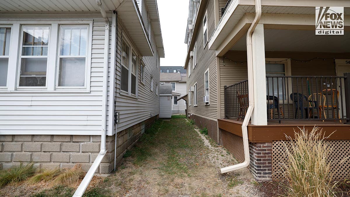 A grass path between two homes