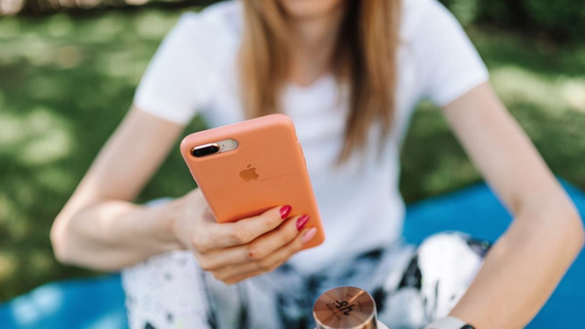 Woman looking down at her phone.