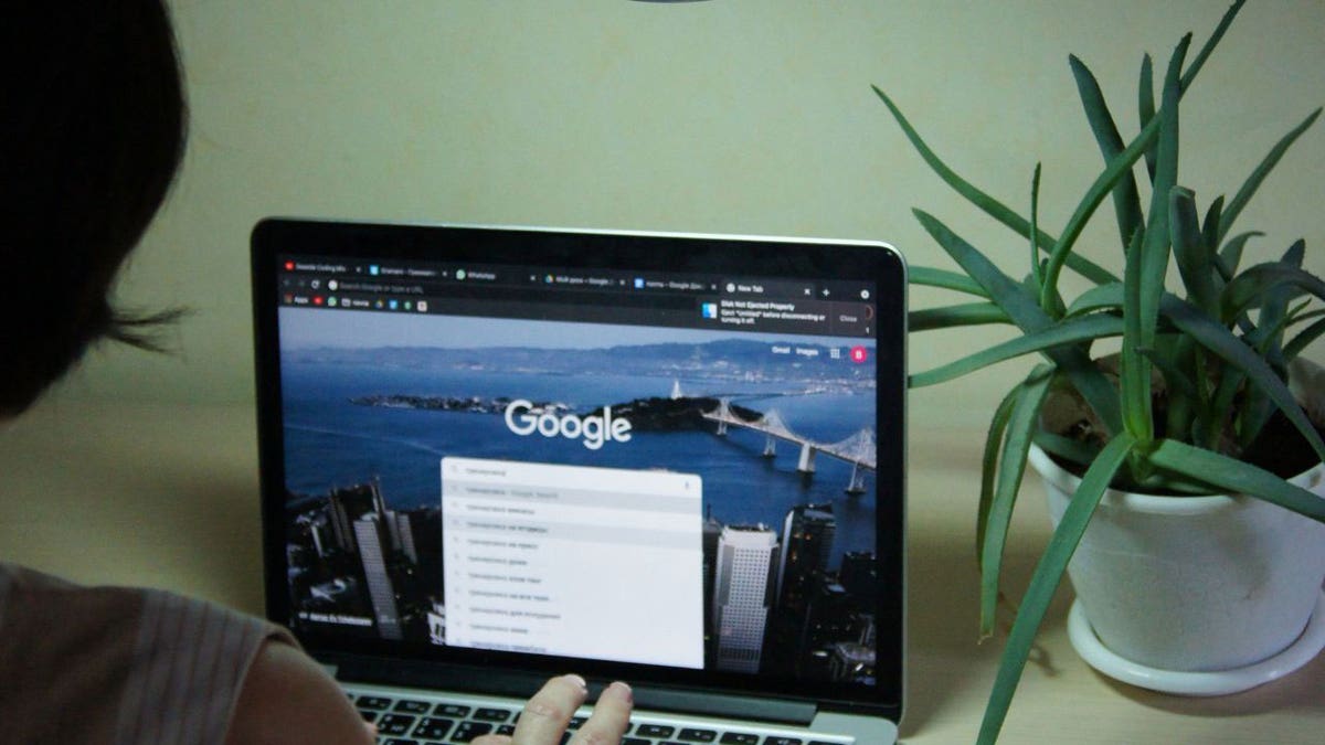 person using laptop with google open