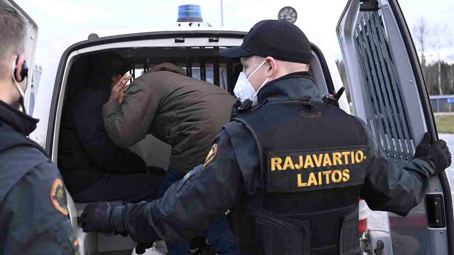 Migrants boarding a van
