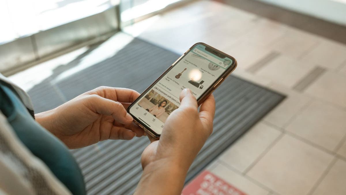 Photo of a man using his iPhone.