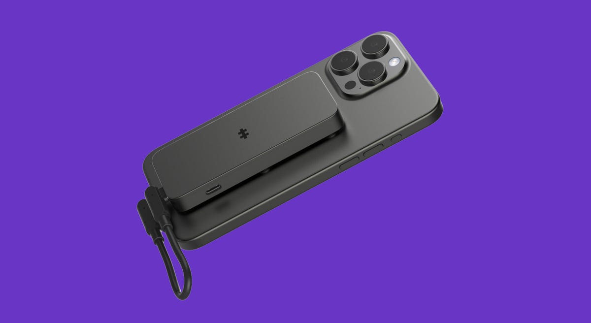 The HyperDrive Next Snap-On USB-C SSD Enclosure attached to the back of an iPhone 15 Pro