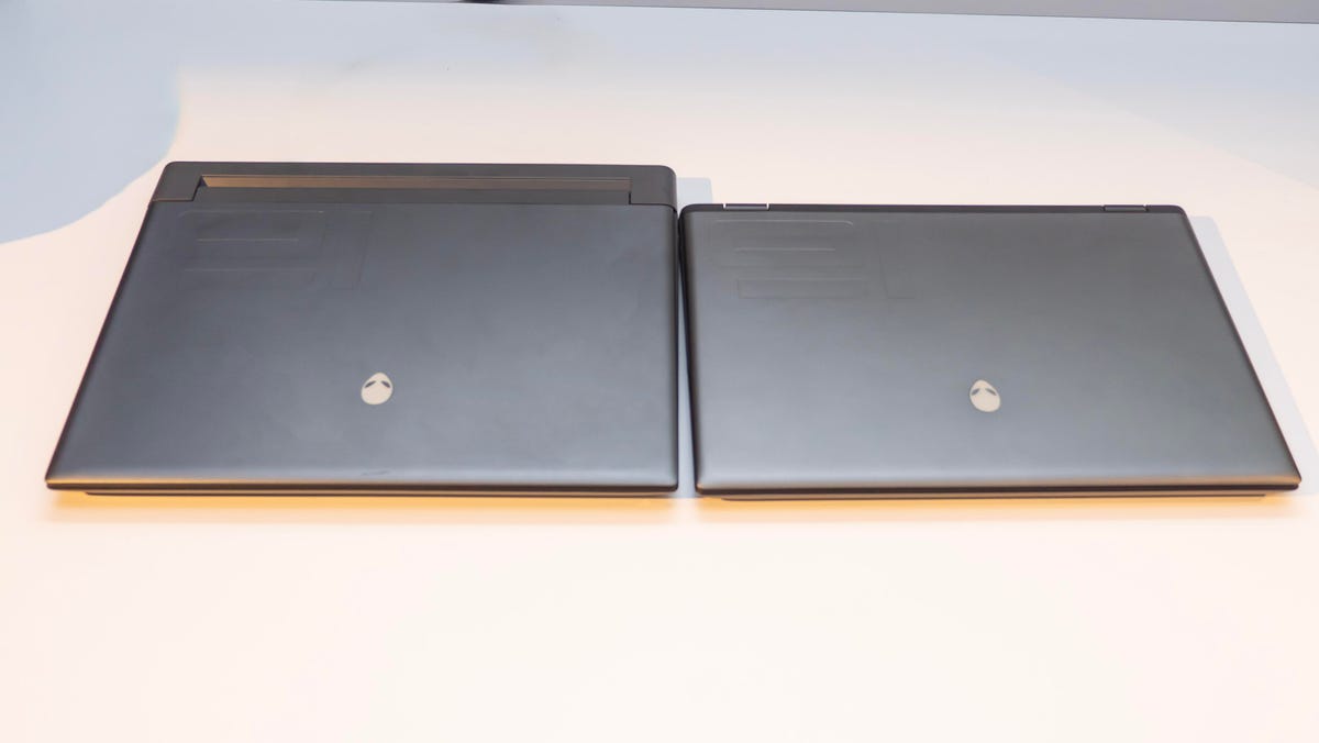 Alienware m16 and m16 R2 gaming laptops closed and sitting side by side.