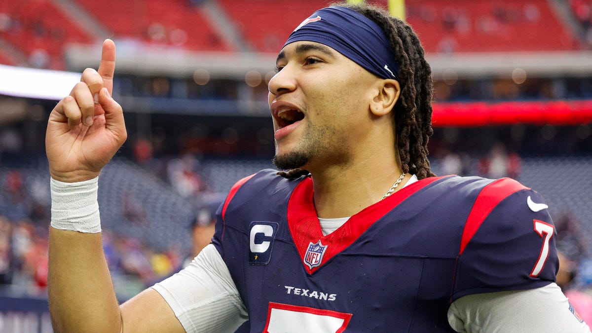 C.J. Stroud of the Houston Texans shouting, side on, pointing finger upwards.