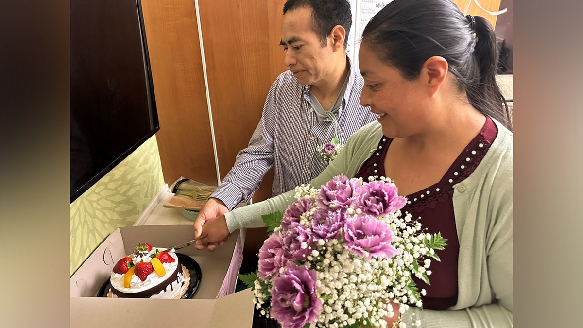 Couple cutting wedding cake