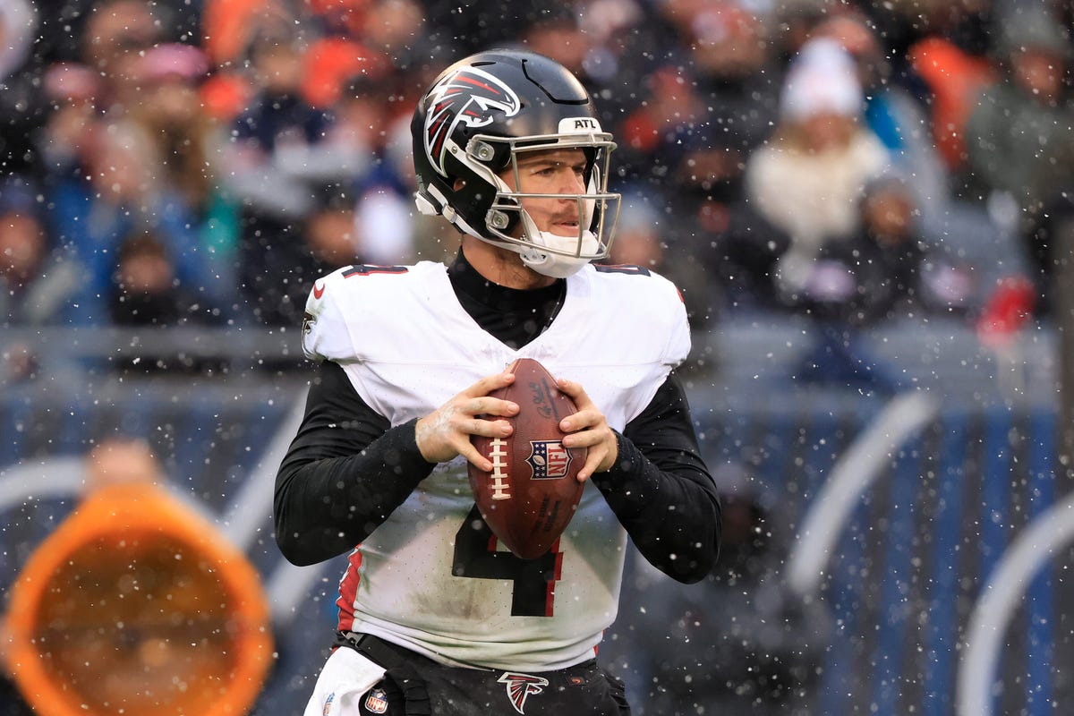 Taylor Heinicke of the Atlanta Falcons grips a football.