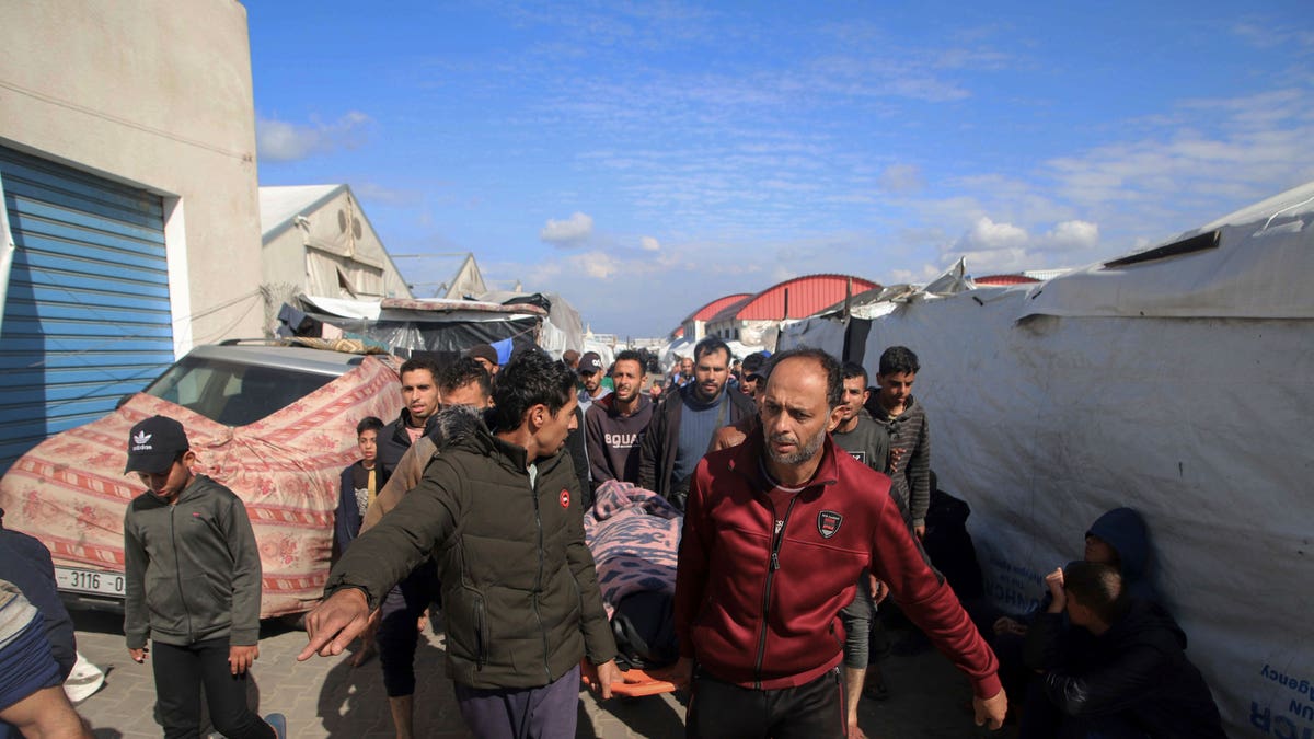 Palestinians carry a a body