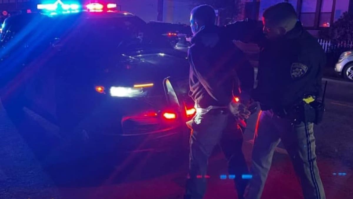 Jeffrey Kendall being arrested by officer