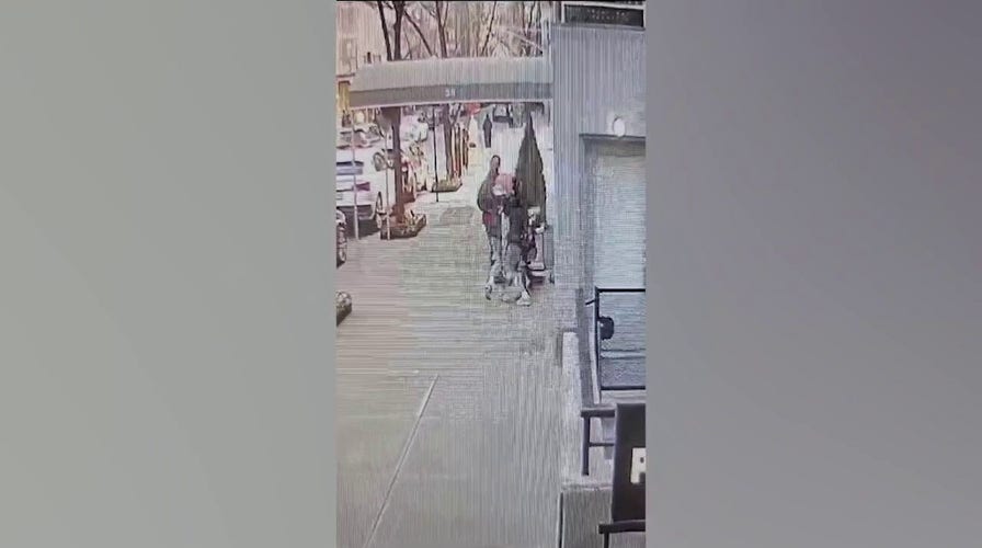 Doorman saves woman from violent robbery as bystanders do nothing on video