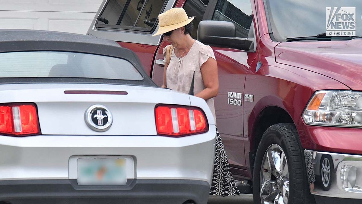 Roberta Laundrie walks to her car outside of her Florida home.