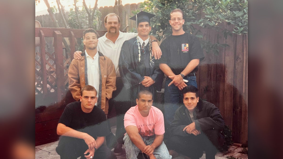 Bruce Bryan and the youths he helped in family photo