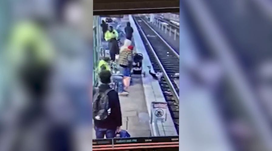 Woman shoves child onto train tracks