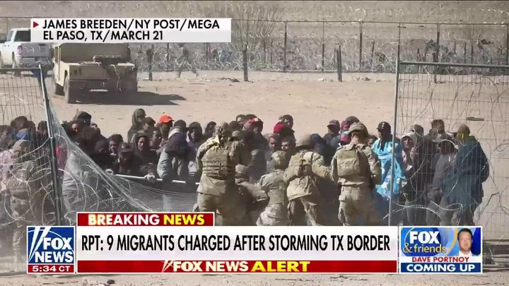 Nine migrants charged with assault, inciting a riot after storming border