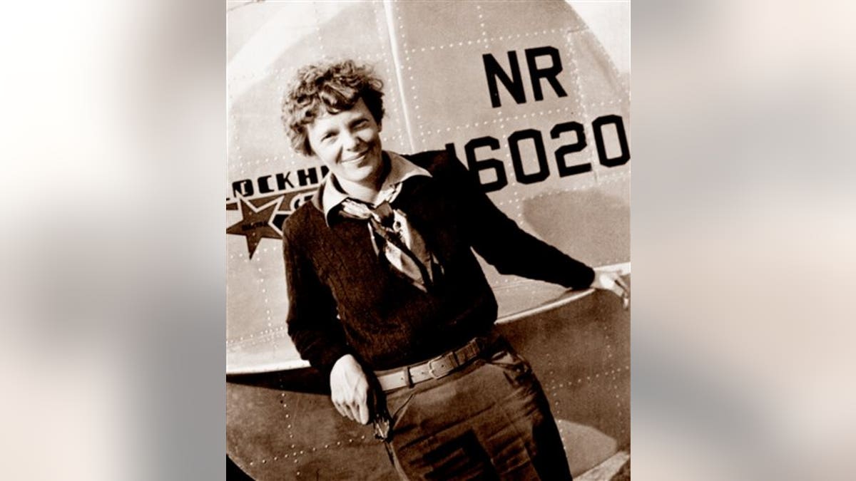 Amelia Earhart in front of plane