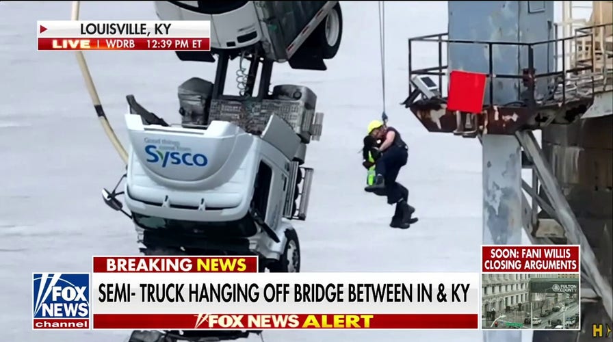 Semi-truck hangs off a Kentucky bridge, rescuers save driver