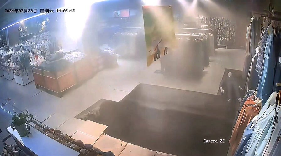 Woman falls into sinkhole as shop floor collapses in China