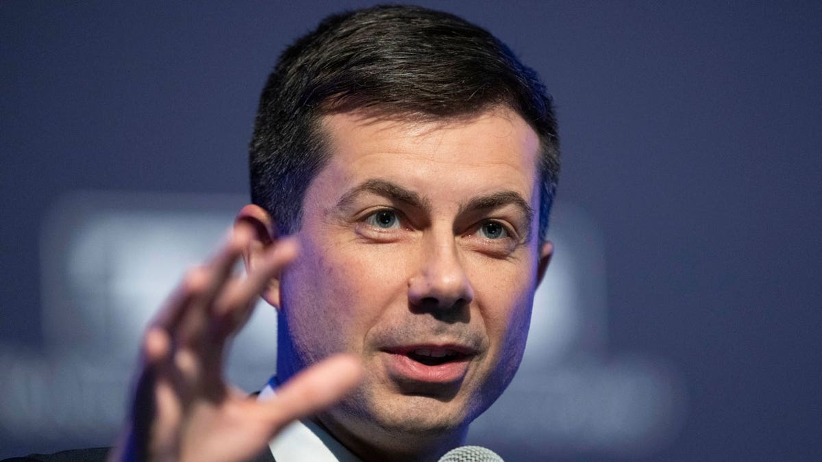 Pete Buttigieg holding microphone