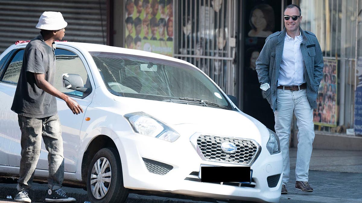 Oscar Pistorius walks to his car