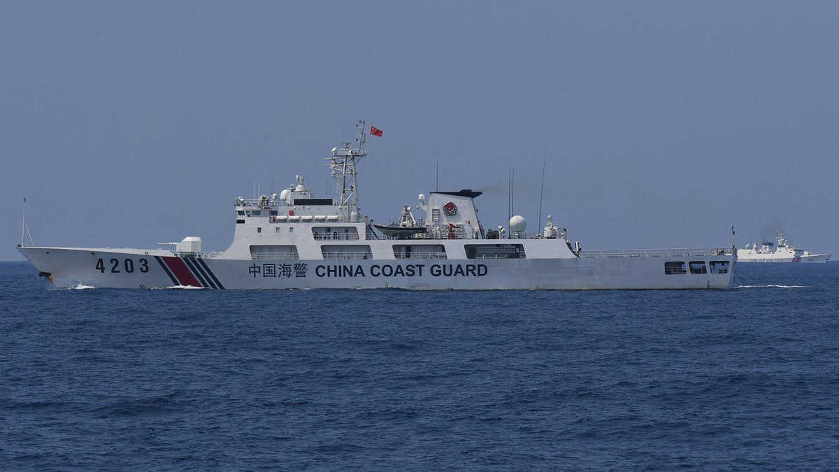 China Coast Guard ships monitor the distribution of fuel and food to fishers by the civilian-led mission Atin Ito (This Is Ours) Coalition, in the disputed South China Sea on May 16, 2024.