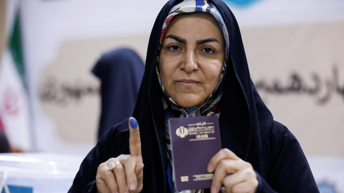 Woman shows her inked finger after voting