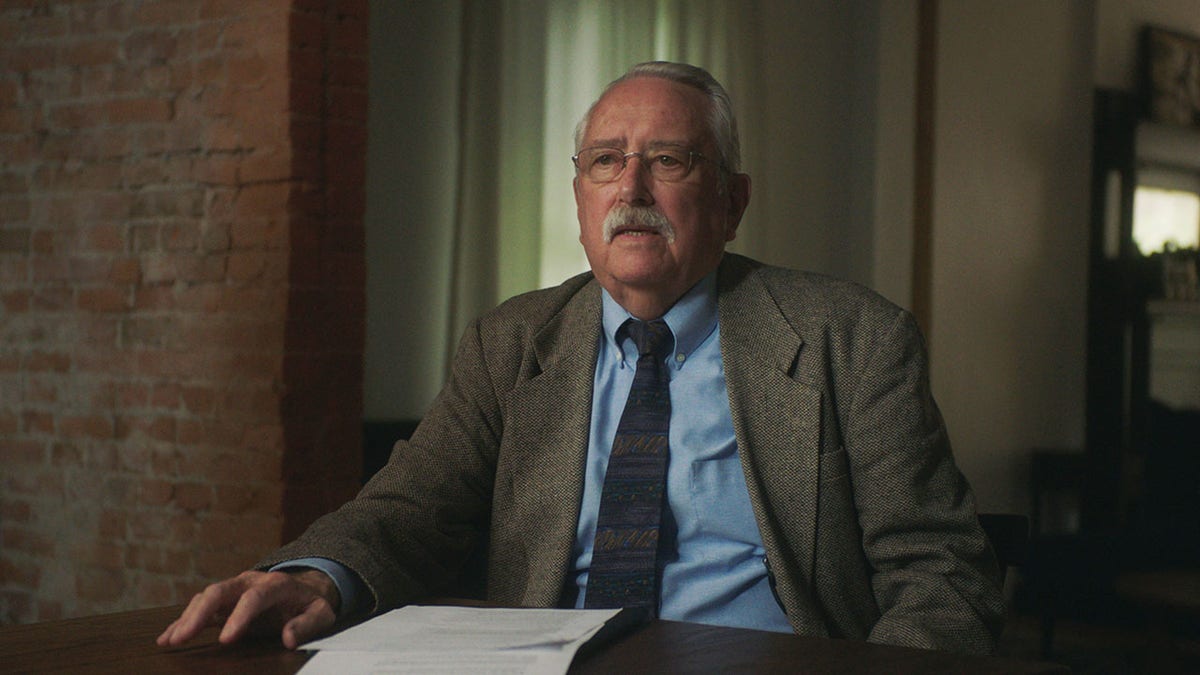 David Messmore wearing a brown blazer and a blue jacket