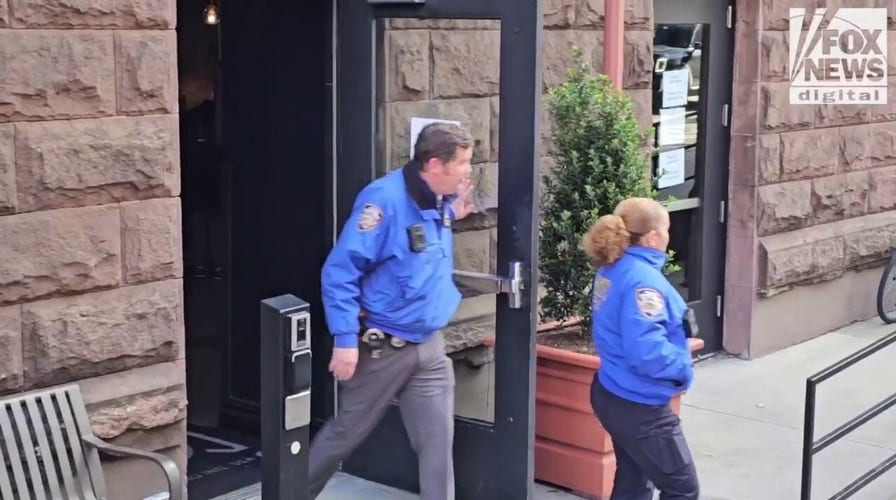NYPD officers depart the AYH Hostel 