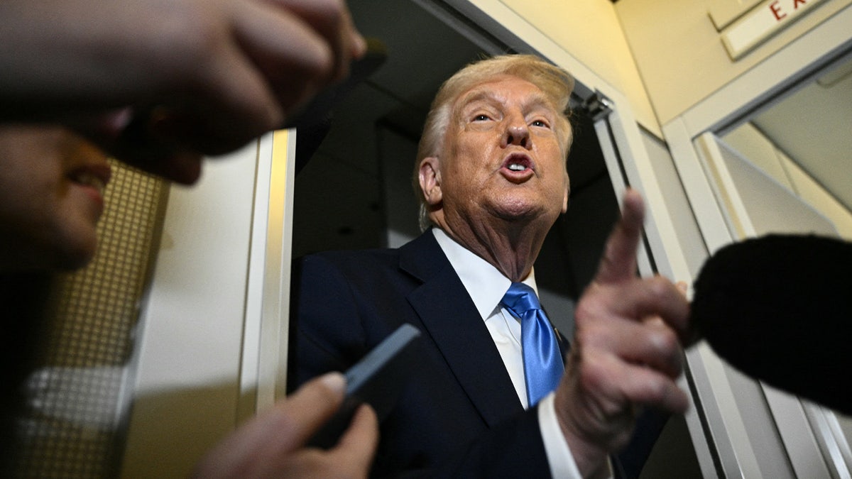 Trump speaks to reporters on Air Force One
