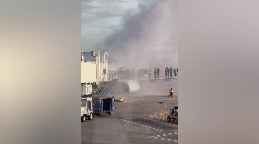 American Airlines plane catches fire at Denver International Airport