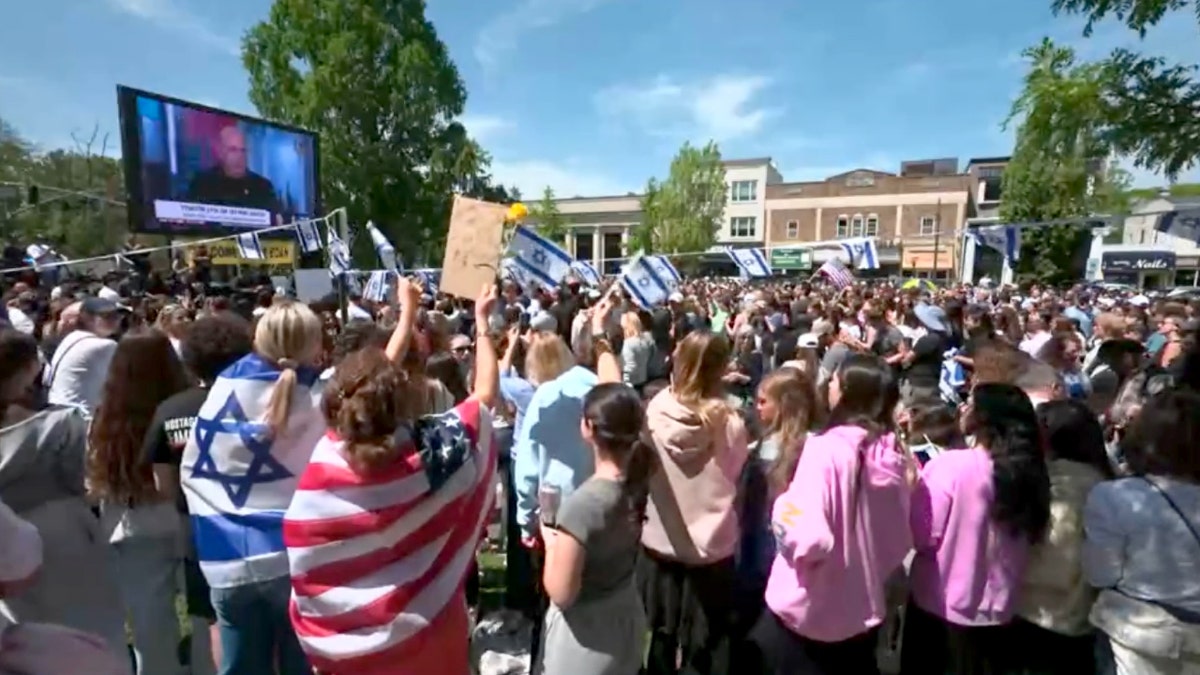 A crowd in Tenafly, NJ, cheers ahead of Edan Alexander's expected release from captivity by Hamas.