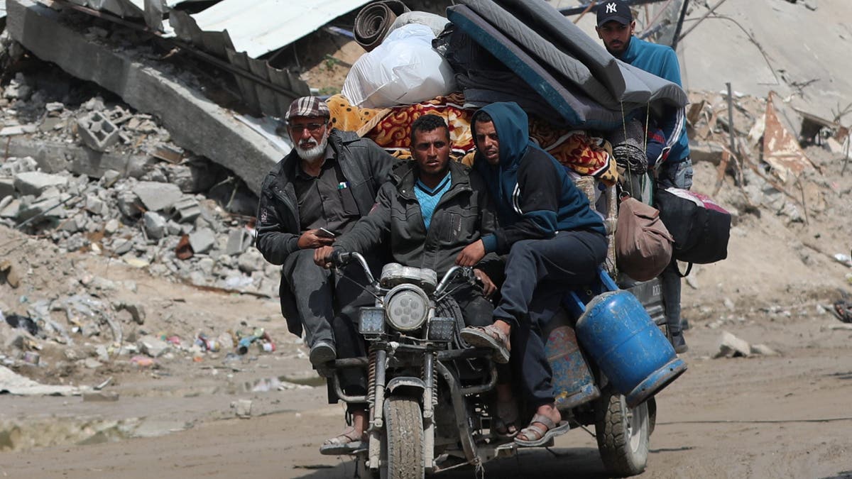 Palestinians make their way with belongings as they flee their homes, after the Israeli army issued evacuation orders, in Jabalia, in the northern Gaza Strip March 25, 2025.
