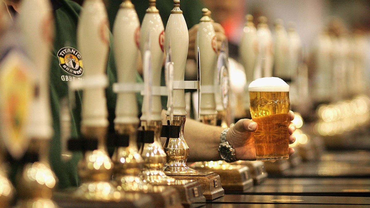 bartender handling pint of beer
