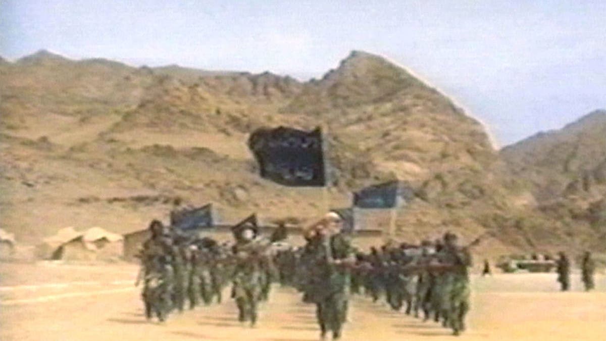 terrorists in fatigues training in desert