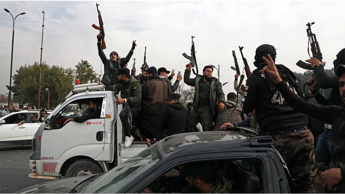 militants celebrating fall of Assad regime in Damascus, Syria