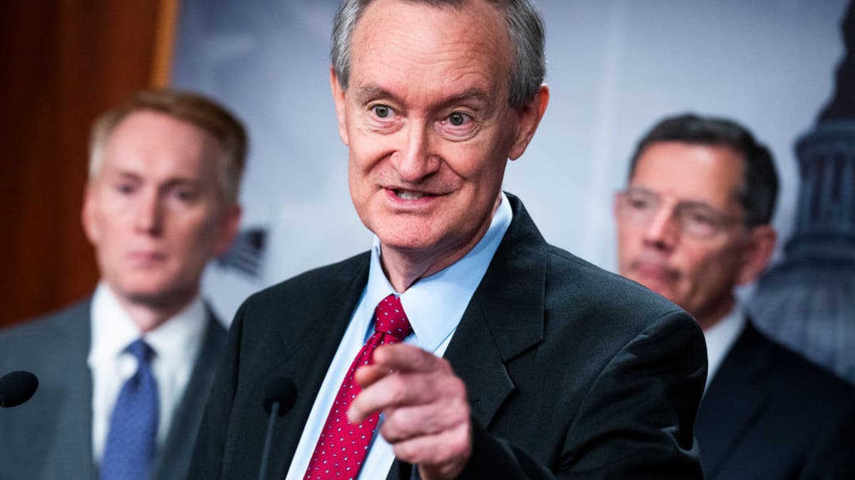 Sen. Mike Crapo gestures during a press conference.