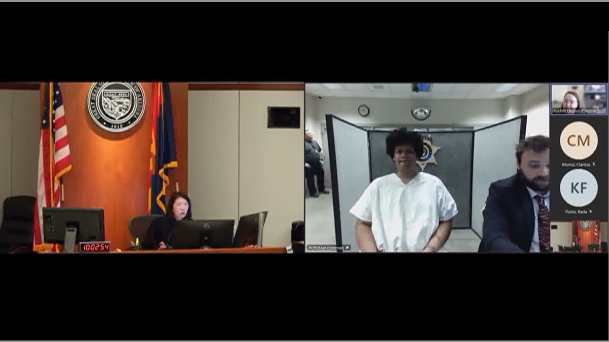 Daniel Michael appears remotely in a white jumpsuit to a Pima County bond hearing