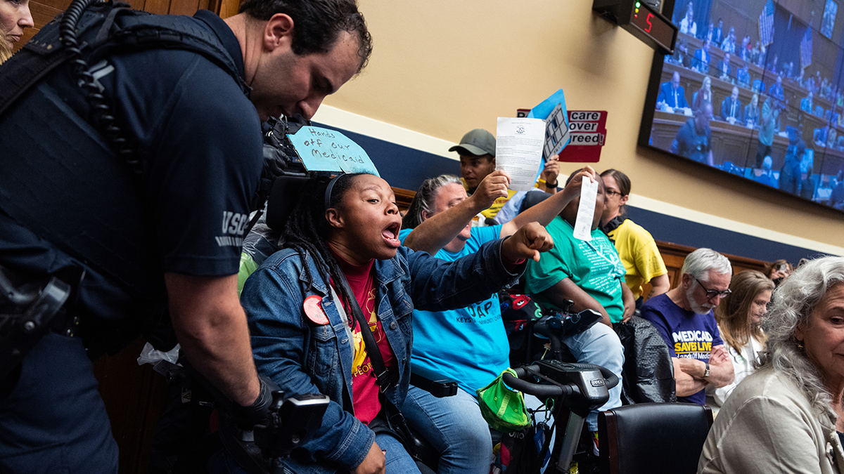 Demonstrators calling for preservation of Medicaid funding, are removed from the House Energy and Commerce markup of the FY2025 budget resolution in Rayburn building on Tuesday, May 13, 2025. 