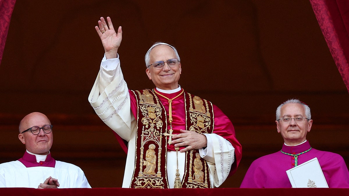  Pope Leo XIV waving to crowd at the Vatican after being elected.