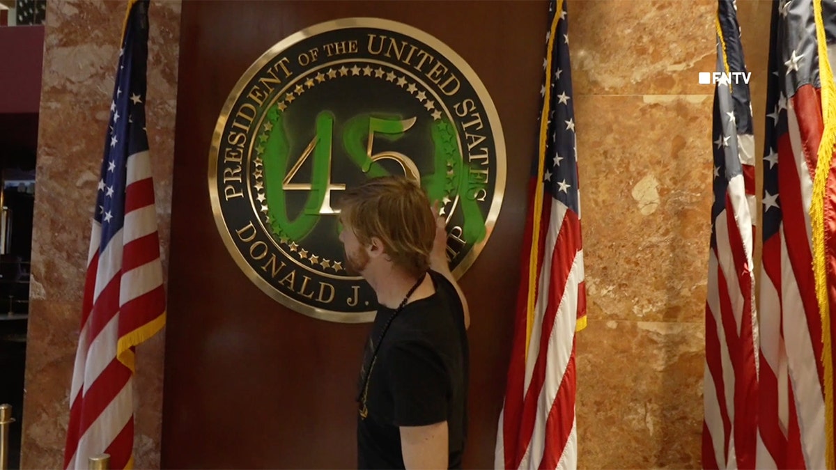 A climate protester vandalizes Trump Tower