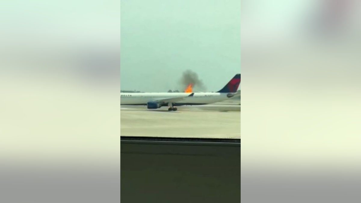 flames shoot out of Delta flight's plane engine