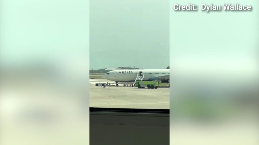 Delta flight evacuated before takeoff after flames seen in engine