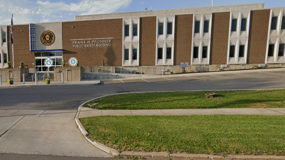 Brig building with sign that says POLICE and a U.S. flag