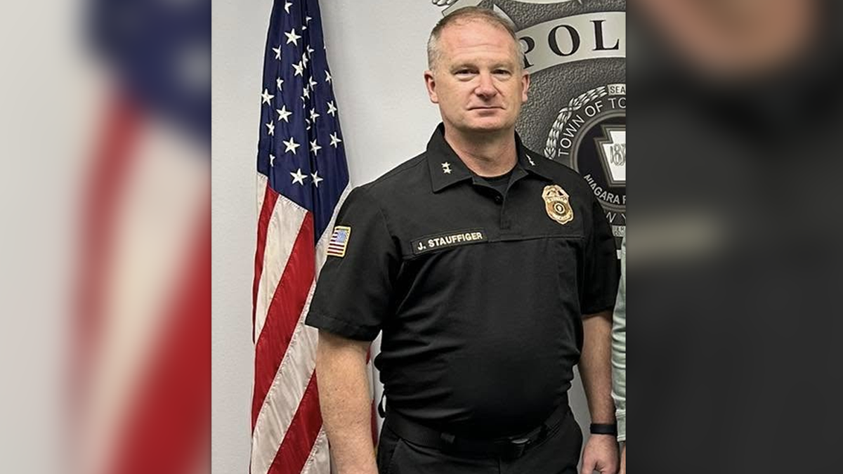 Stauffiger in front of a US flag at the Tonawanda Police department headquarters