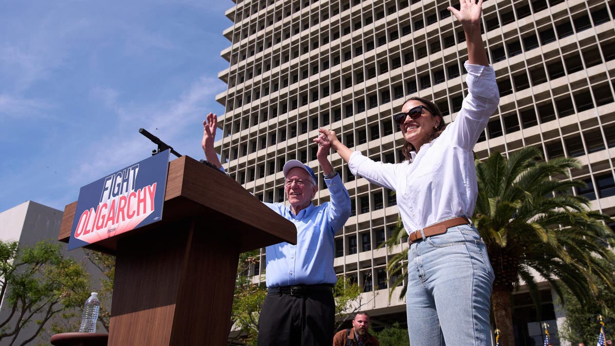 Sanders and AOC on podium at rally