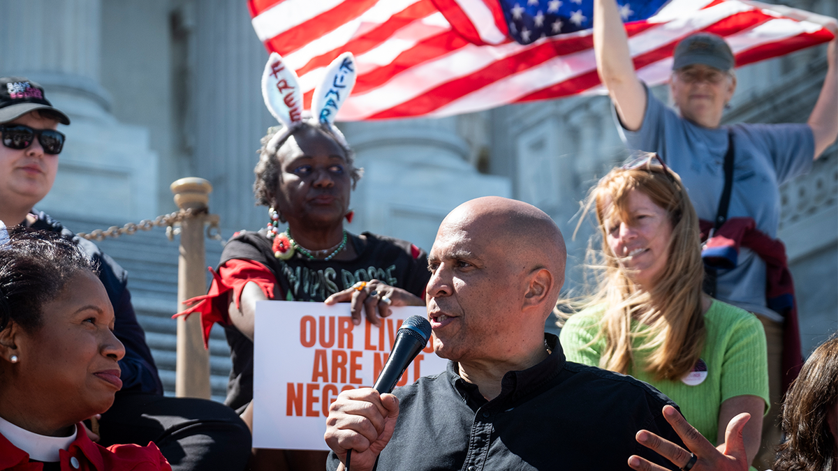 Sen. Cory Booker, D-N.J., center, and House Minority Leader Hakeem Jeffries, D-N.Y., hosted a livestreamed sit-in against the GOP funding plan on the steps of the House of Representatives on April 27, 2025 in Washington, D.C.