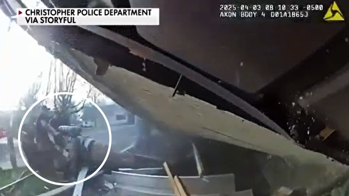 Christopher police pull the trapped firefighter from the beneath the collapsed roof.