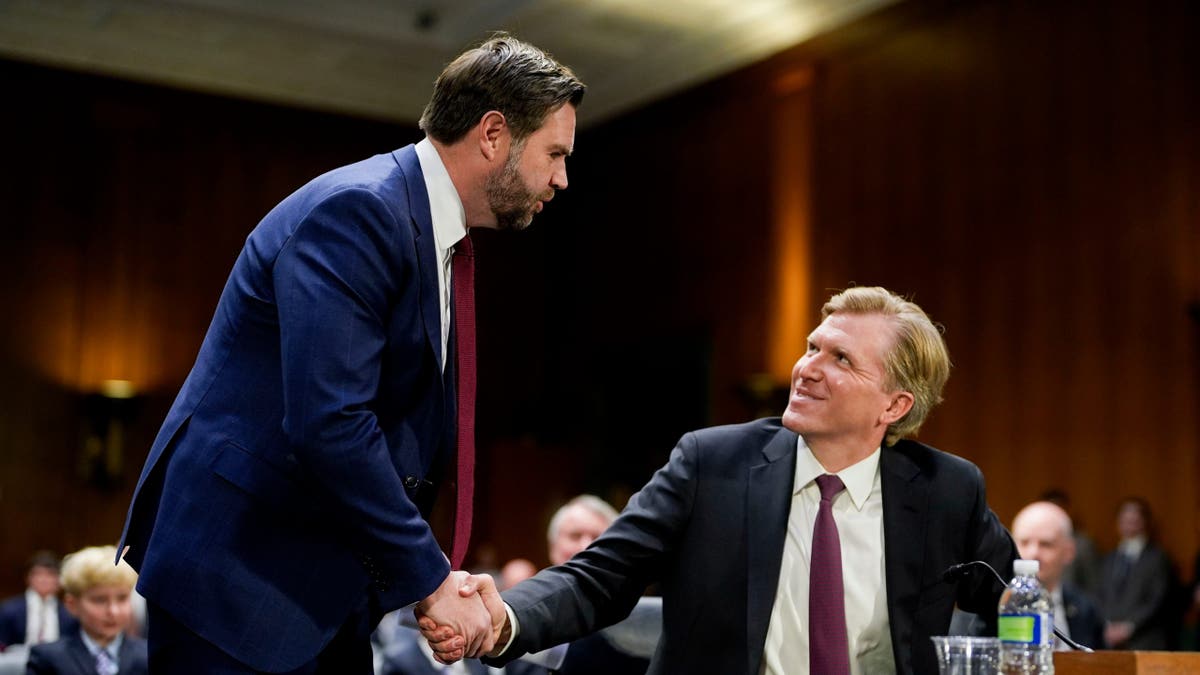 US Vice President JD Vance, left, and Elbridge Colby, under secretary of defense for policy nominee for US President Donald Trump, shake hands during a Senate Armed Services Committee confirmation hearing in Washington, DC, US, on Tuesday, March 4, 2025
