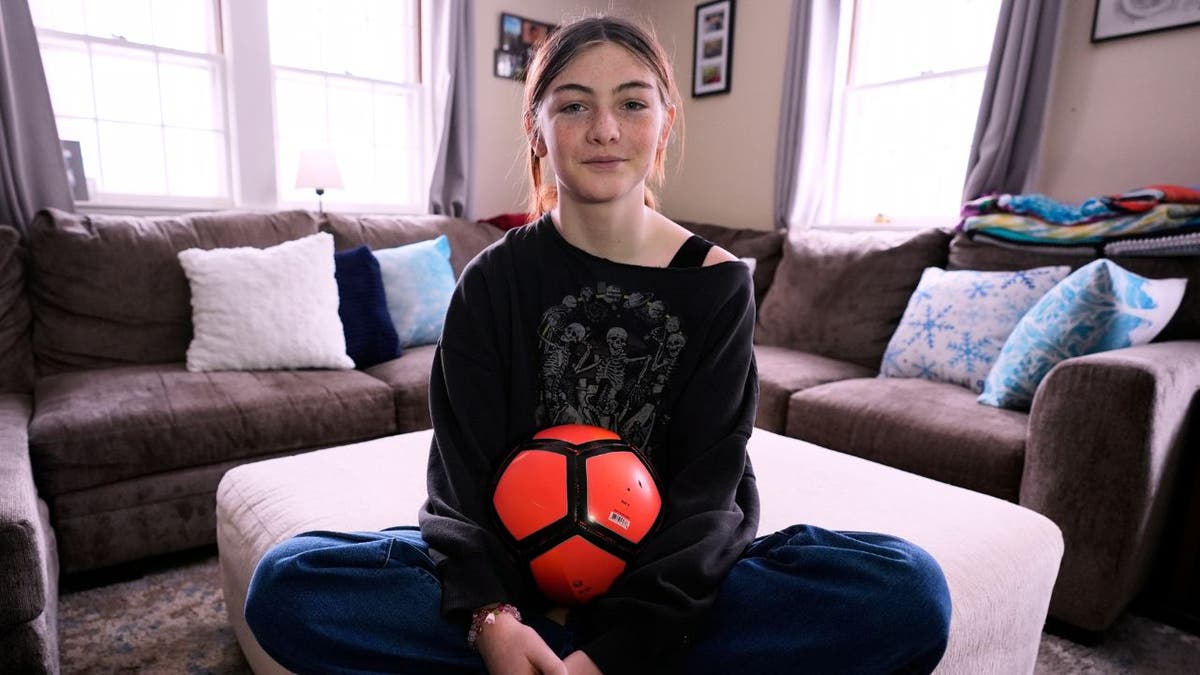 Transgender athlete Parker Tirrell with a soccer ball
