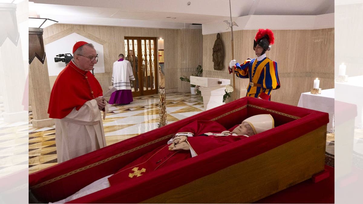 The body of Pope Francis lays in state in a coffin in the Vatican